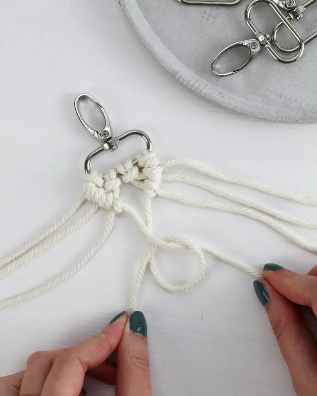 Makramee ist weiterhin im Trend und neben den klassischen Wandbehängen gibt es viele weitere Anwendungsmöglichkeiten. Im letzten Jahr habe ich mir sogar eine eigene Handtasche geknüpft. Vor ein paar Wochen bin ich nach Paris gereist und dafür brauchte ich eine kleine Umhängetasche, die ich gut vorne tragen kann. Parallel knüpfte ich an einem anderen Makrameeprojekt: einem Makramee-Übertopf mit dickerem Makrameegarn. Dabei kam mir die Idee, dass ein DIY Makramee Schultergurt aus diesem dicken Makrameegarn sicherlich toll aussähe. Also habe ich mich auf die Suche nach einer passenden Umhängetasche begeben, bei der ich den Schultergurt einfach abmachen kann, um später meinen eigenen Makramee Schultergurt daran zu befestigen. So kann man die Schultergurte beliebig wechseln. DIY Makramee Schultergurt knüpfen - 4 Anleitungen - diy makramee schultergurt handtasche knuepfen rippenknoten 11